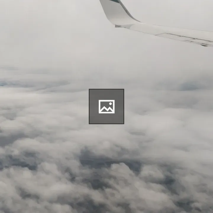 Airplane Wing in Cloudy Sky
