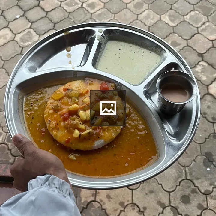 Person holding dish with vegetable-studded sauce