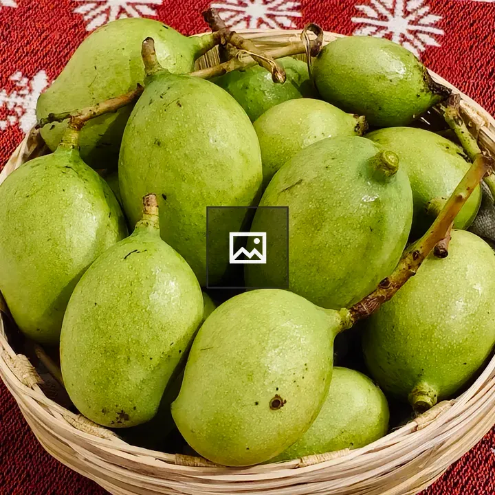 Fresh green mangoes in basket