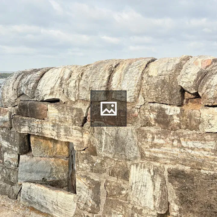 Weathered stone wall with opening