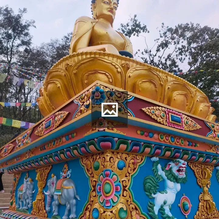Golden Buddha statue on ornate base