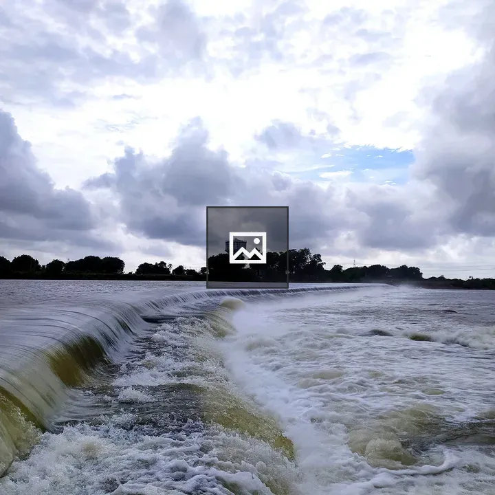 Waterfall over a low dam