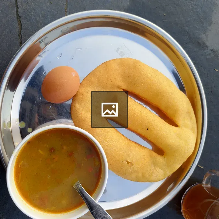 Curry in a white bowl with egg