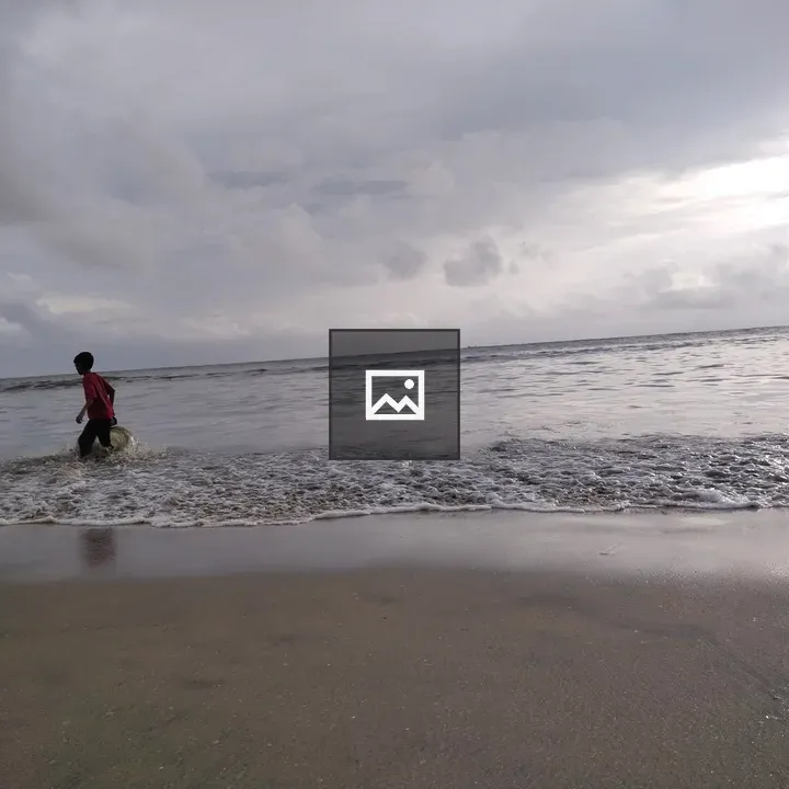 Person Walking on Beach Shore