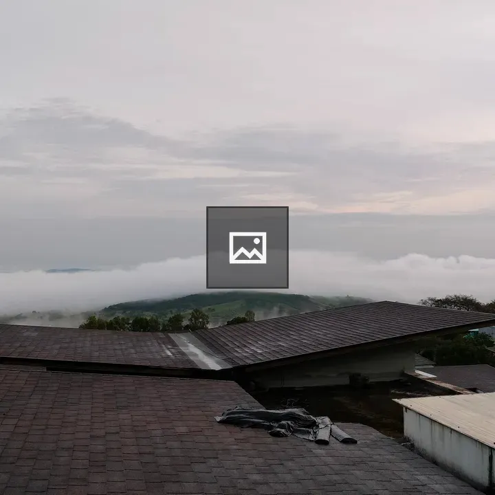 Village rooftops under cloudy sky