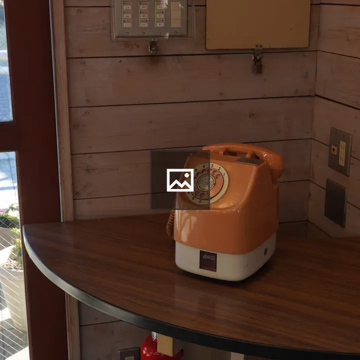 Orange and White Telephone on Table