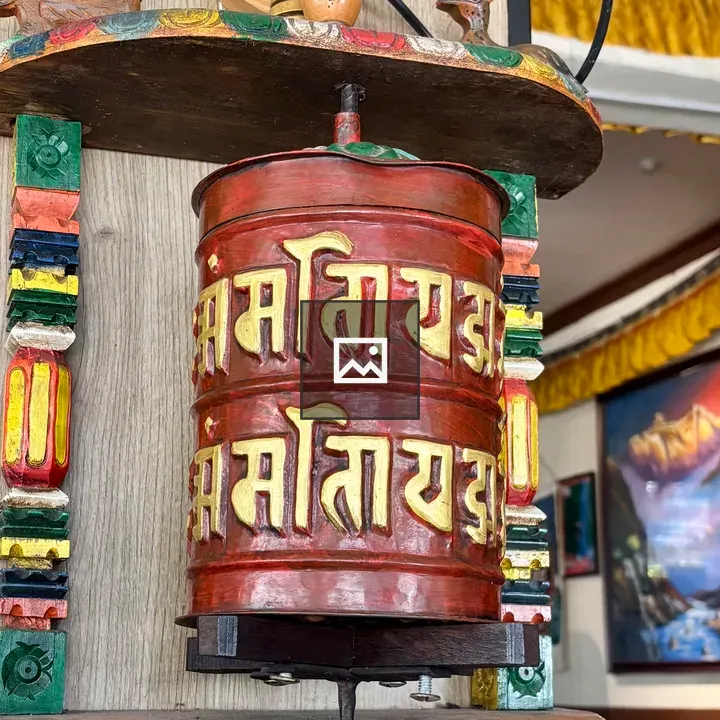 Colorful prayer wheel in rustic room