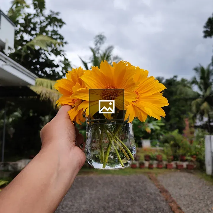 Yellow flowers in a glass pot