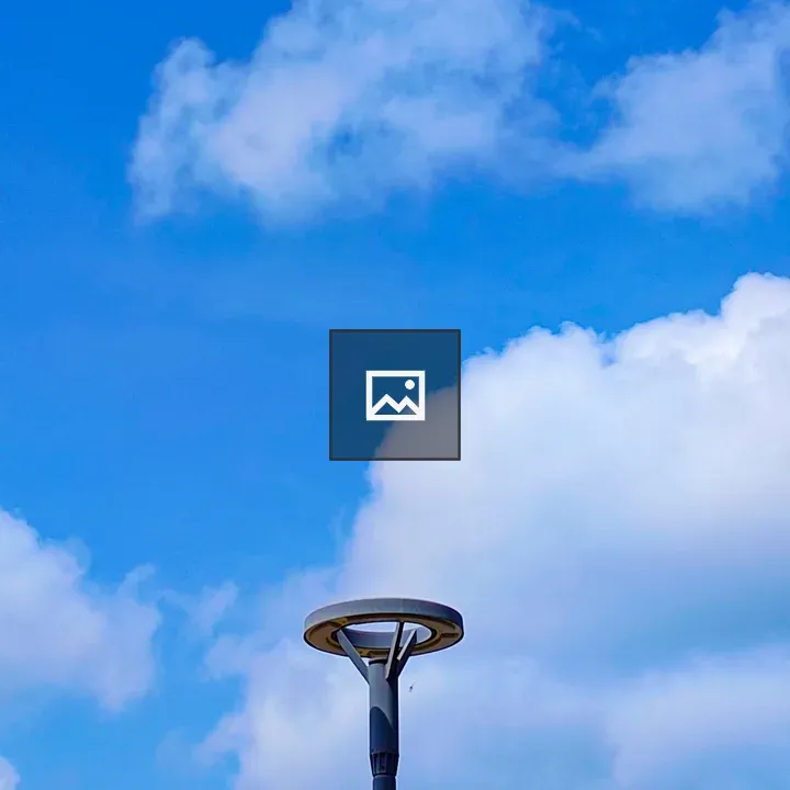 Modern street lamp against blue sky