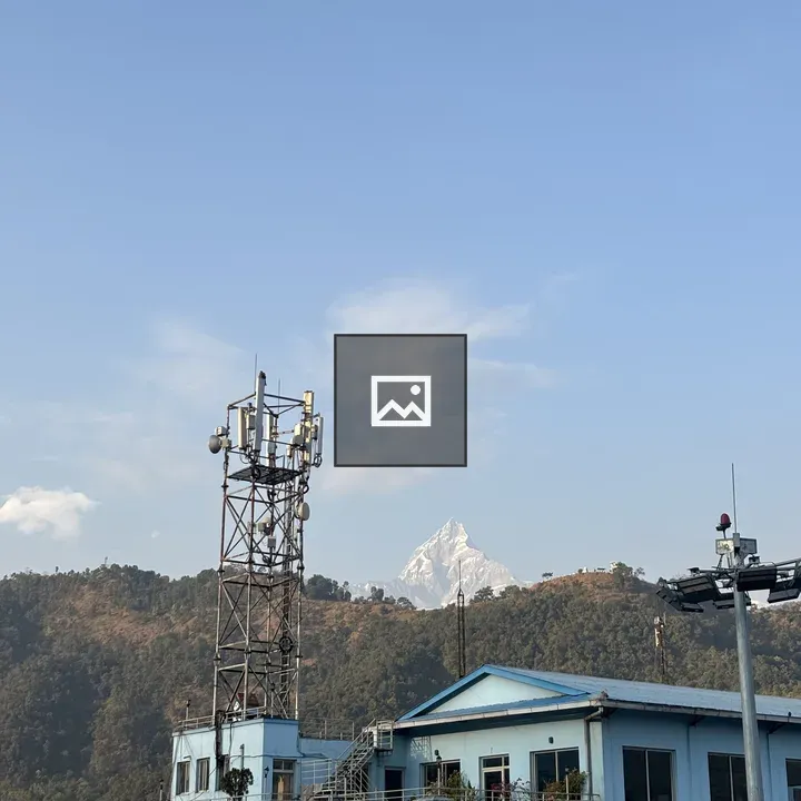 Mountain Peak Behind Blue Building