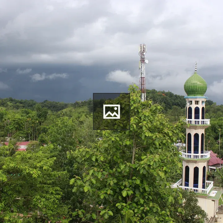 Tall mosque tower with green dome