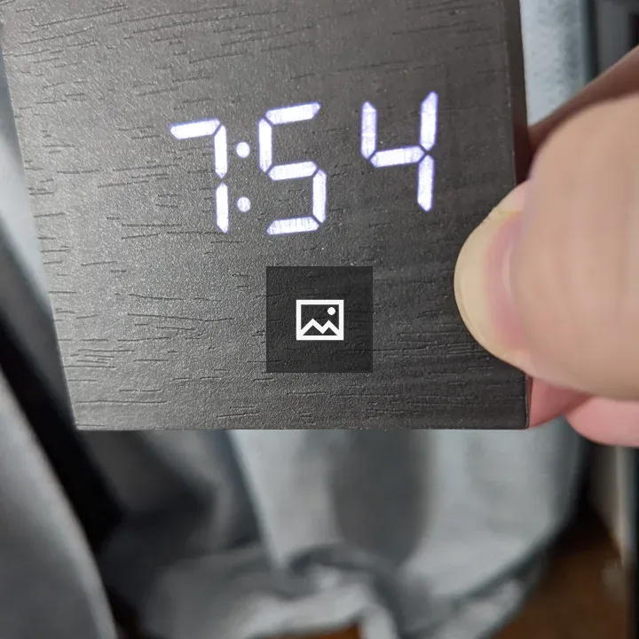 Square digital clock in hand