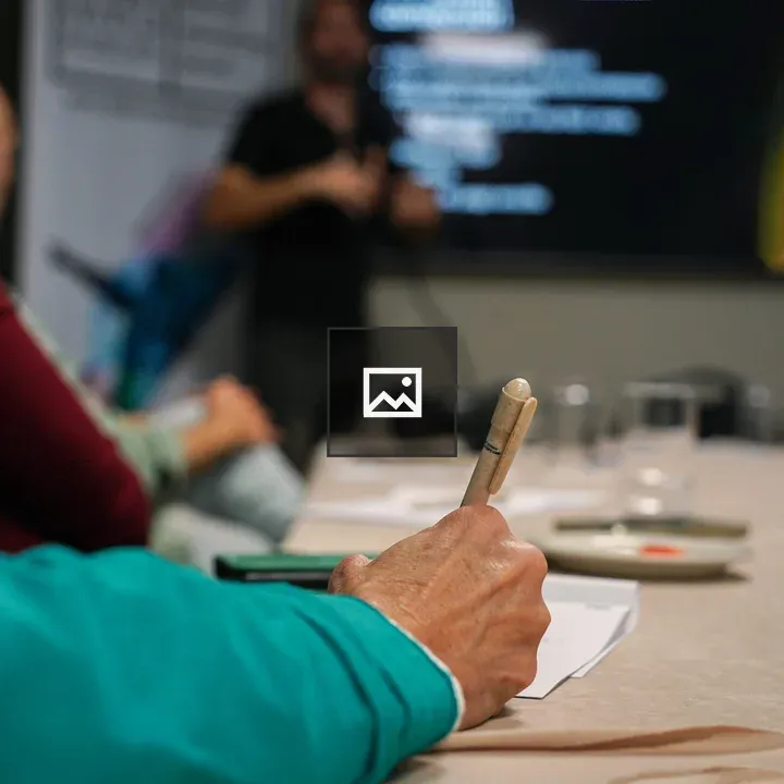 Person taking notes at a presentation