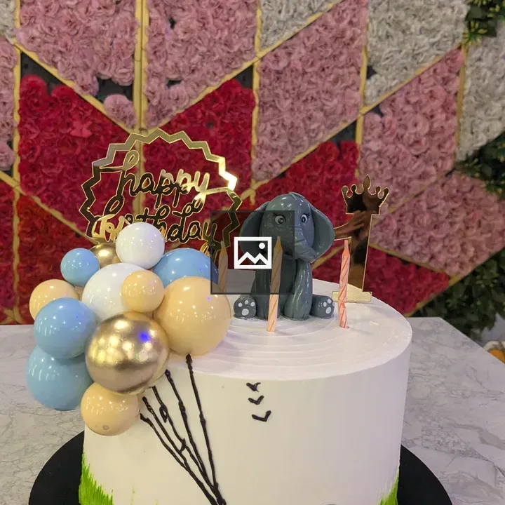 Cake with elephant pictures and birthday tag