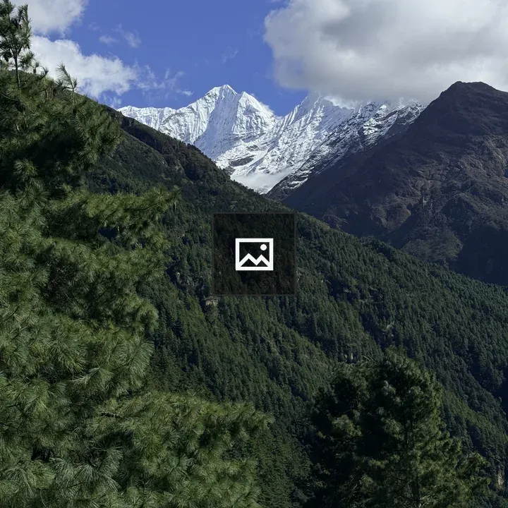 Snow-capped Mountains Over Green Hills