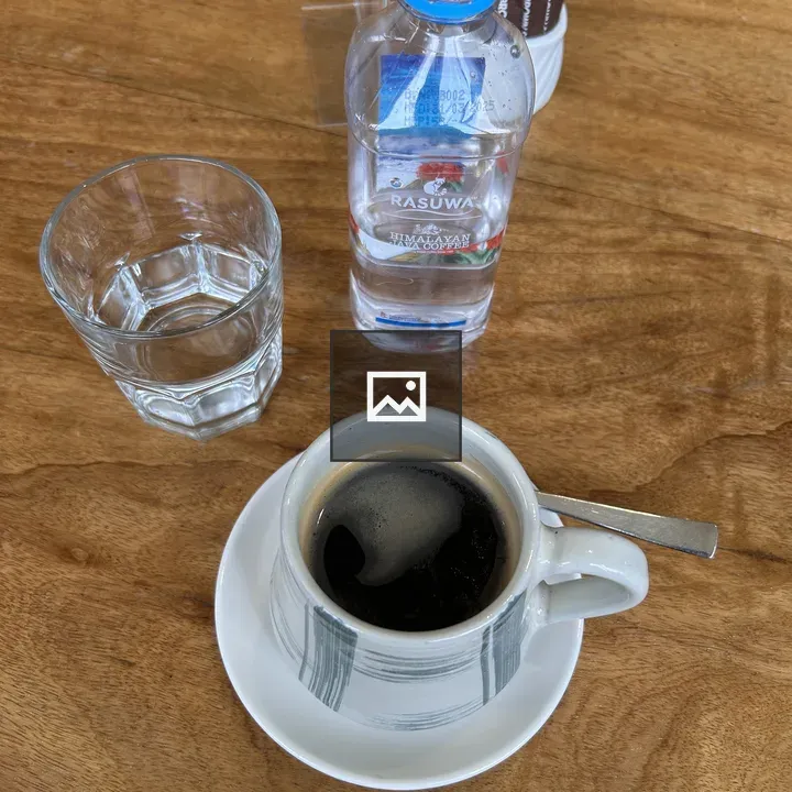 Cup on White Saucer with Spoon