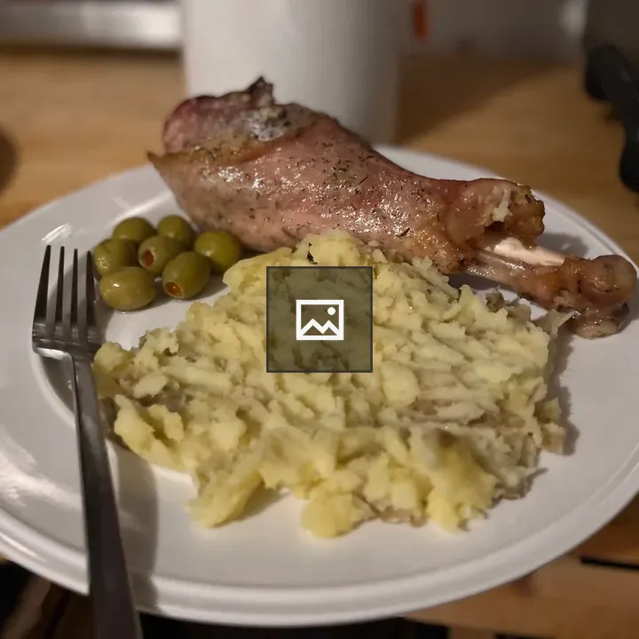Turkey, potatoes, and olives on plate