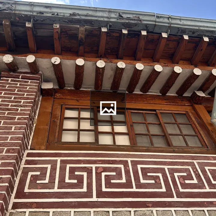 Exterior building with wooden overhang and window
