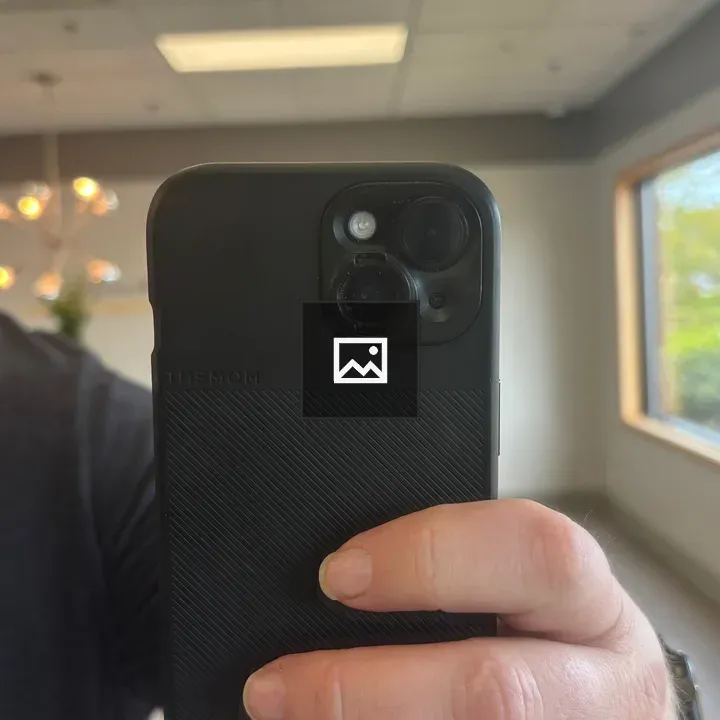 Hand holding a black phone case