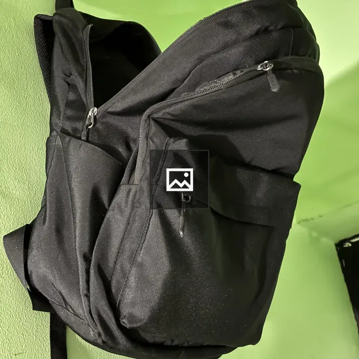 Backpack against green wall