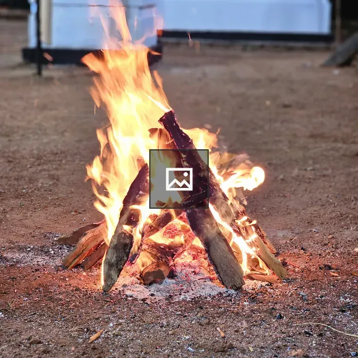 Wooden flames in triangular log setup