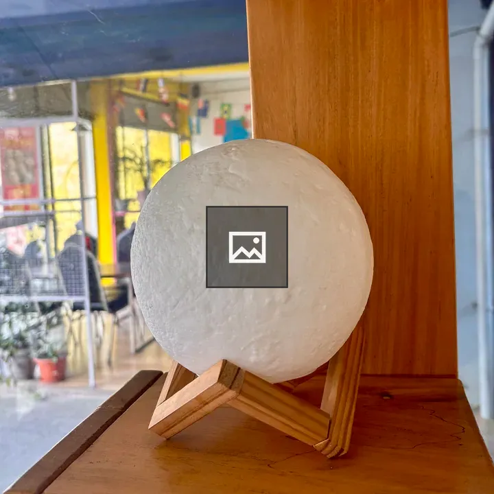 White sphere on wooden stand
