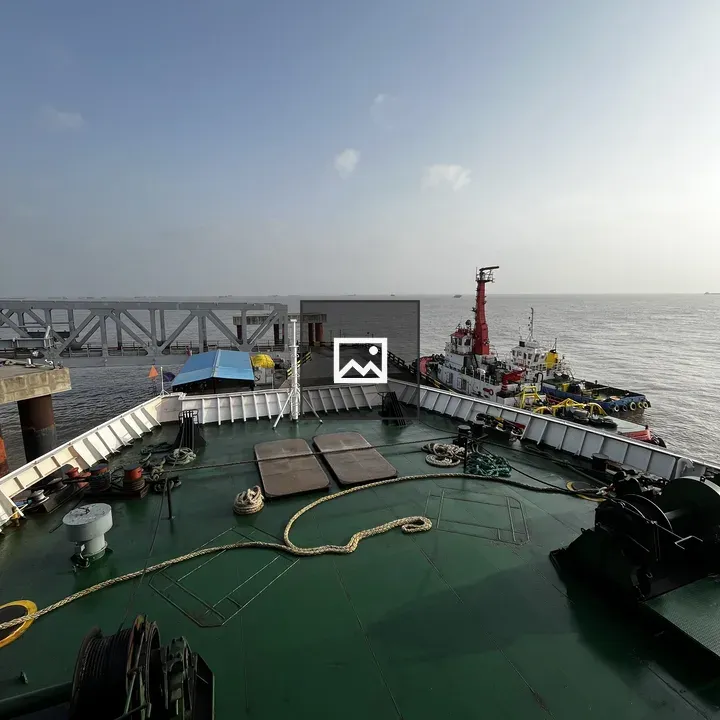 Deck view of ship with tugboats