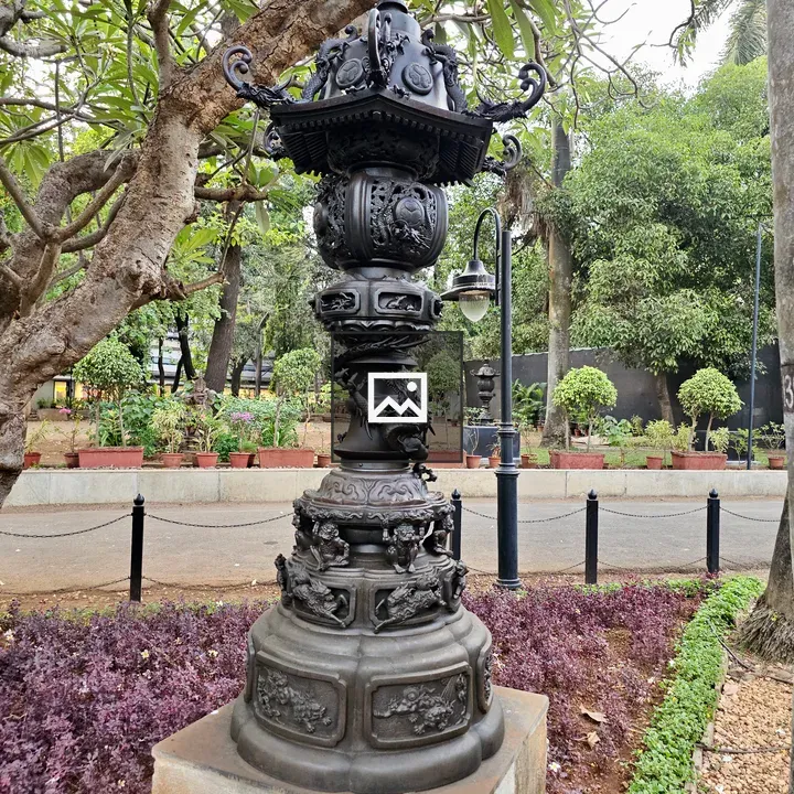 Black metal lamp post in garden