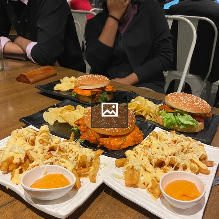 Sesame seed burgers on wooden table