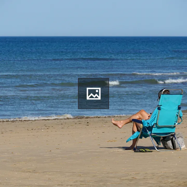 Person in blue beach chair