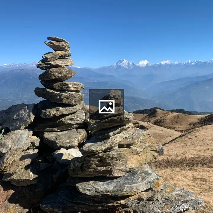 Stacked stones with mountains