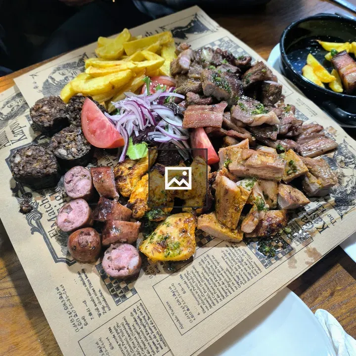 Platter of grilled meats with sides