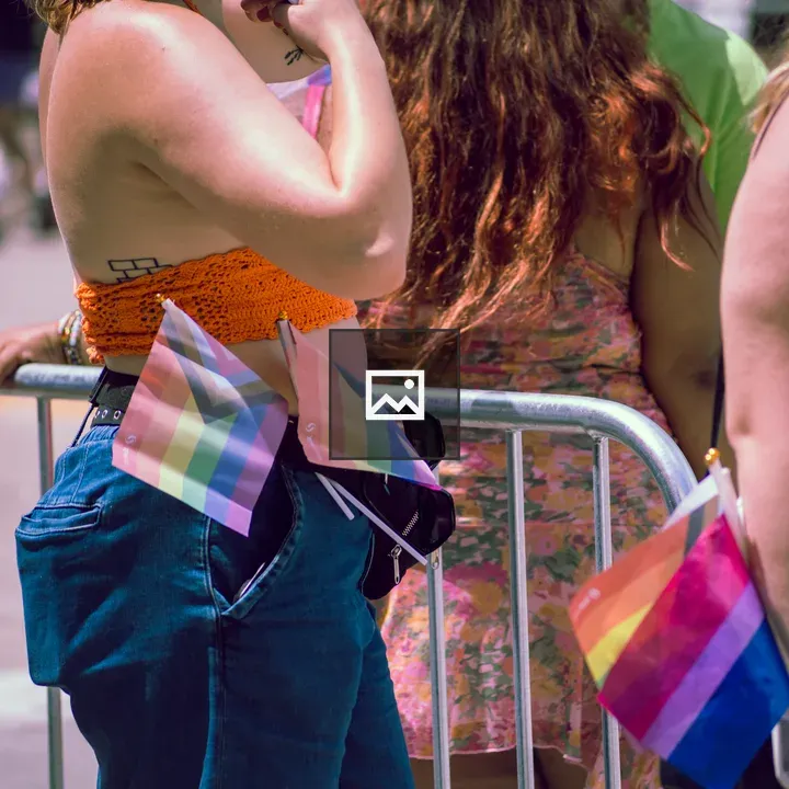 Pride Event Attendees with Progress Pride Flags
