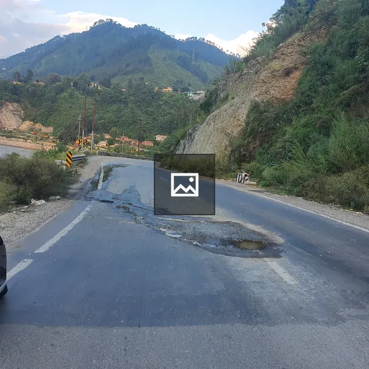 Road by pothole and mountains