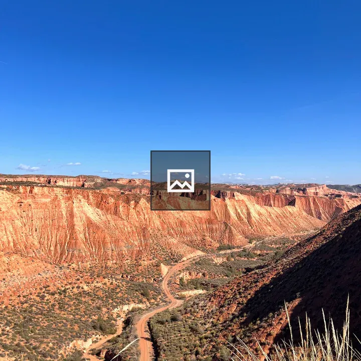 Winding dirt road through desert canyon