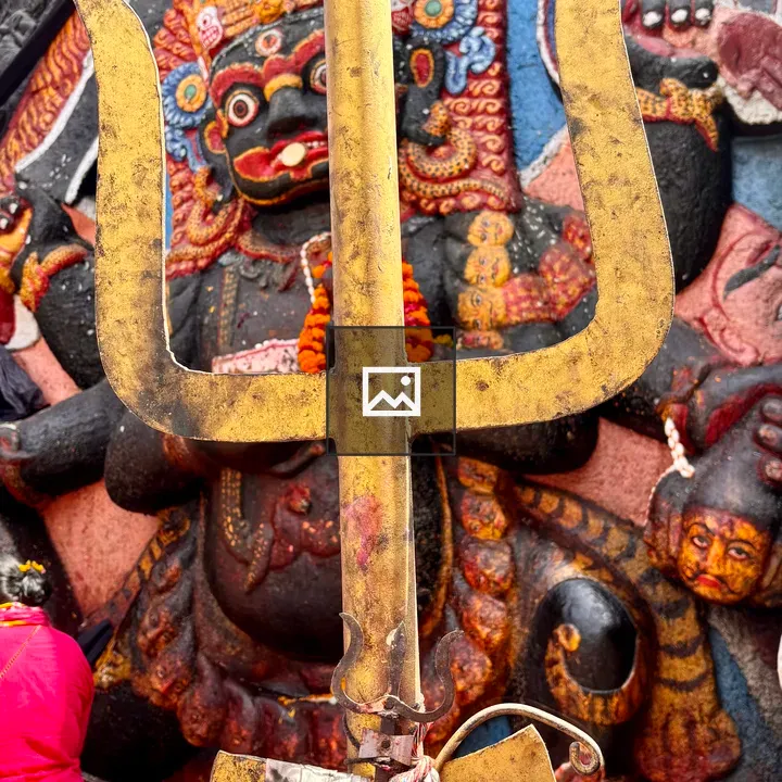 Golden trident with deity statue