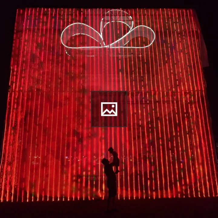 Person Holding Child Silhouette with Red Gift