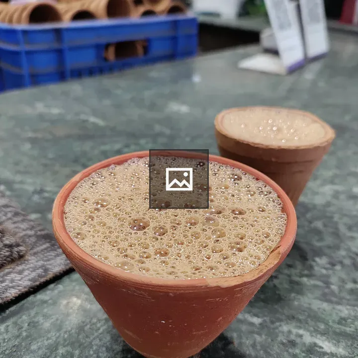Frothy tea in a clay cup