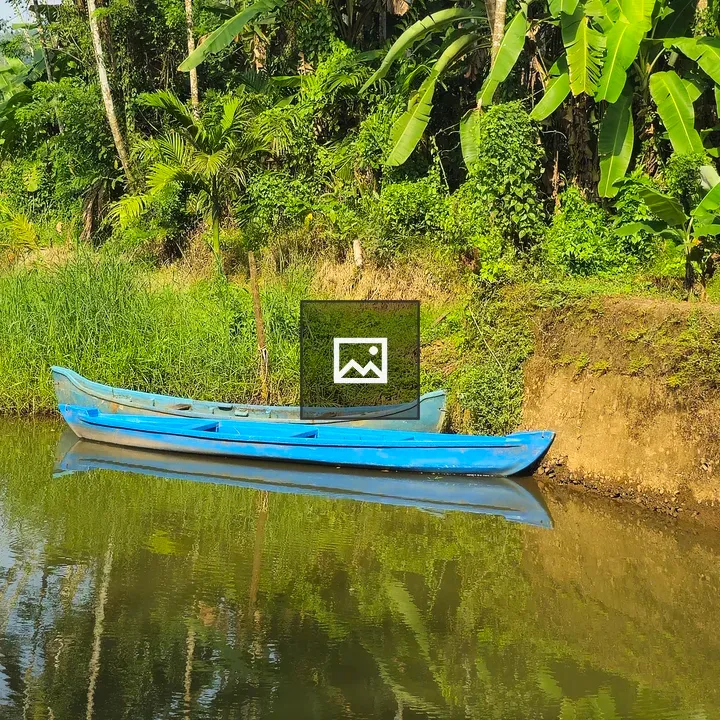 Two blue boats on calm canal