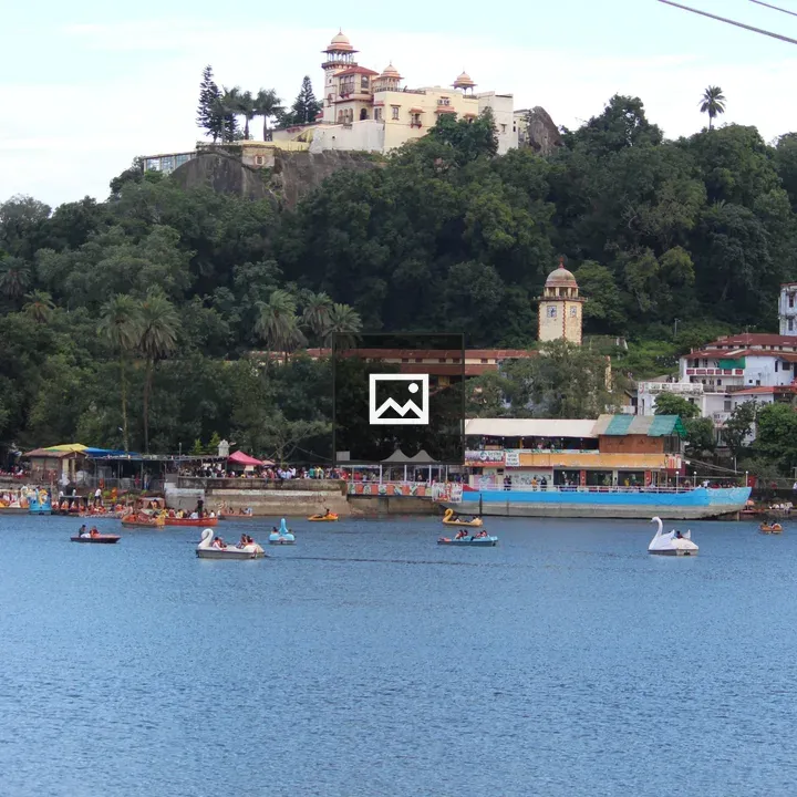 Boats on a Lake with Mount Abu Palace