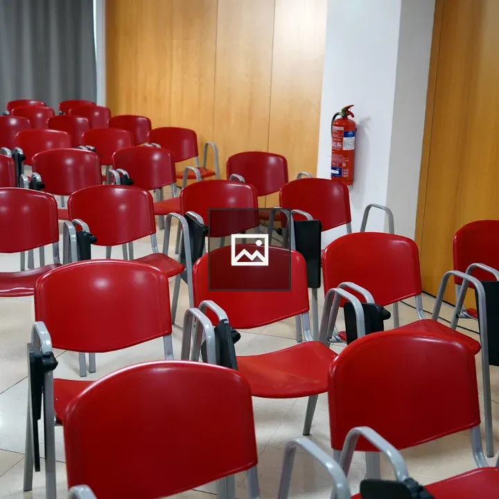 Row of red chairs in seminar room