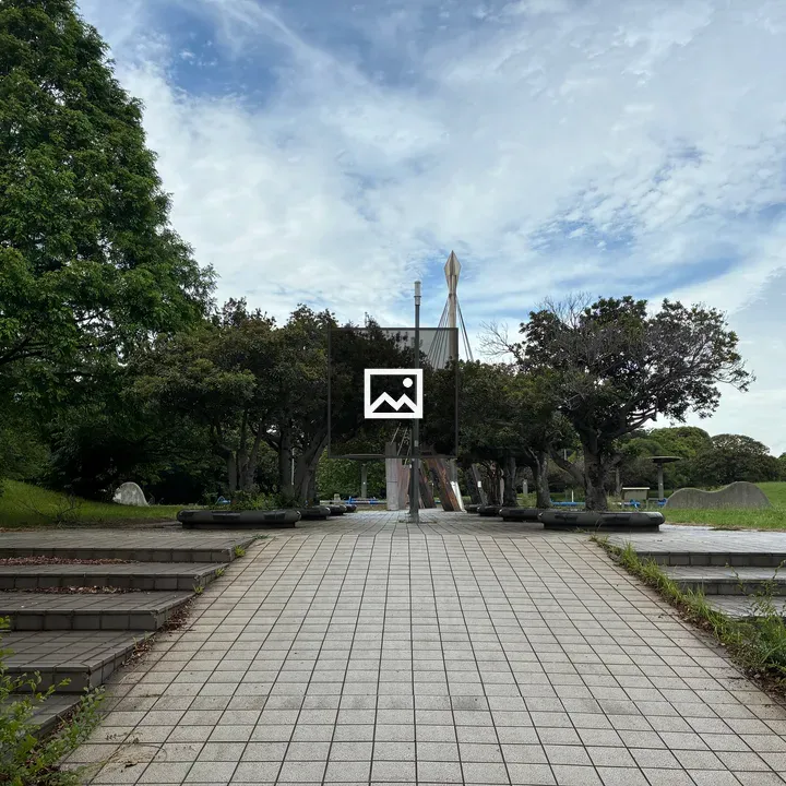 Paved walkway with greenery at Chiba Port Park