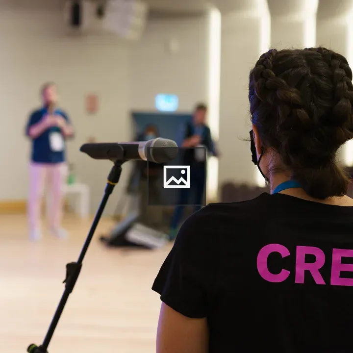 Crew Member at Microphone Stand