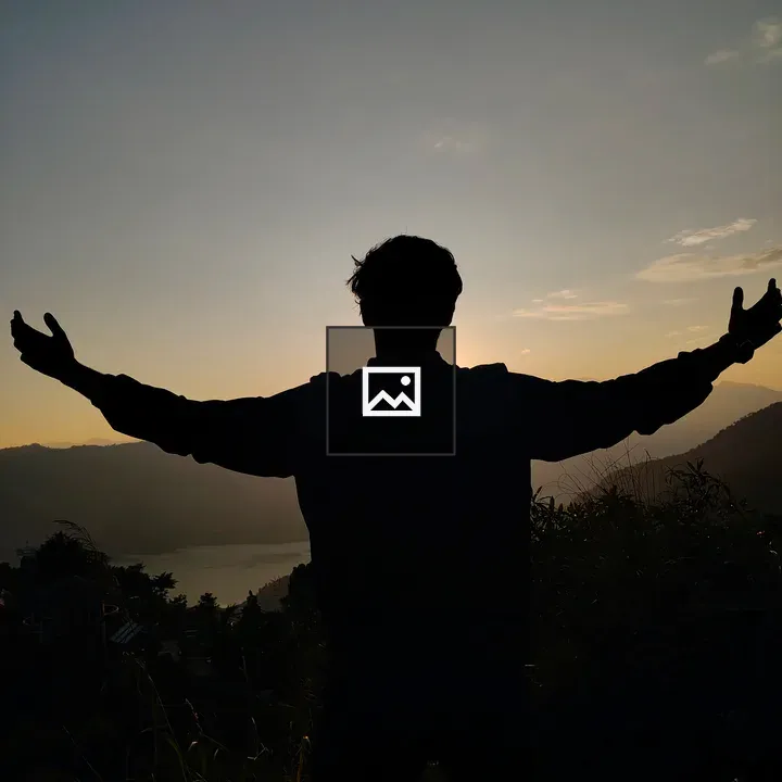 Silhouette at Sunset Over Hills and Water