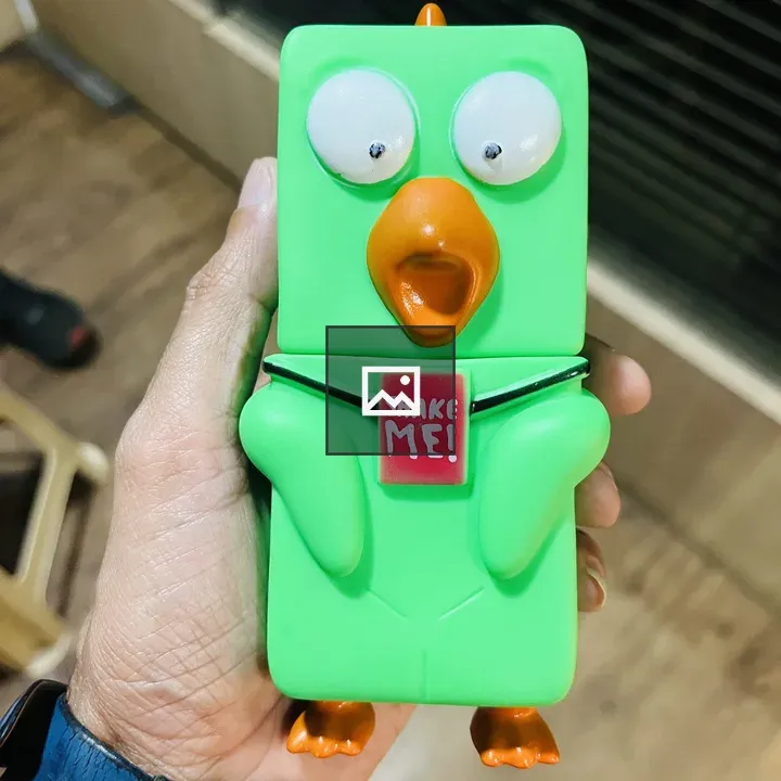 Green toy bird held by person