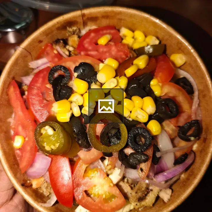 Colorful salad in brown bowl
