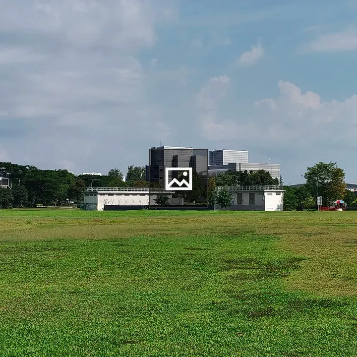 Grassy field with building in background