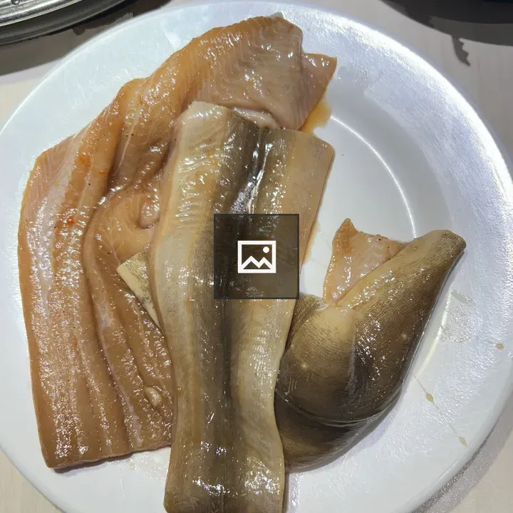 Fish fillets on white plate