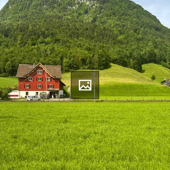 Red house in countryside landscape