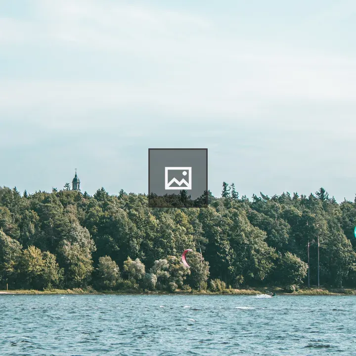 Forested Shoreline with Beach House and Kite Surfers